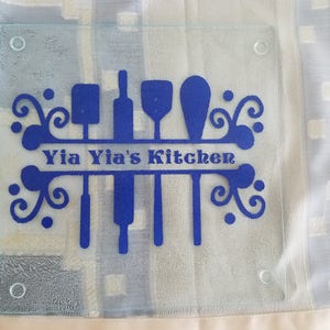 yia yia&#39;s kitchen , grandma, nonna, oma, abuela, glass cutting board