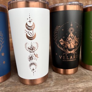 20oz Coffee Tumbler in colors white, black, red, blue and green. Design is engraved through the color to reveal the copper base layer. Design is based on the fictional book A Court of Thorns and Roses.