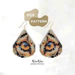 May include: A pair of teardrop-shaped beaded earrings featuring a tiger eye pattern in shades of orange, black, white, and blue. The earrings hang from gold-toned metal hooks. The image includes the text PDF PATTERN and WirrWarr JEWERLY DESIGNER.
