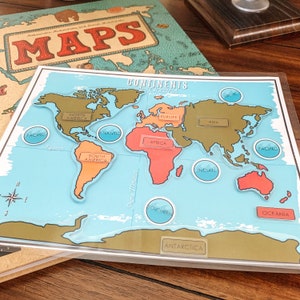 May include: A colorful world map with continents and oceans labeled. The map is divided into continents, including North America, South America, Europe, Asia, Africa, Australia, and Antarctica. The oceans are labeled Pacific, Atlantic, Indian, and Southern.