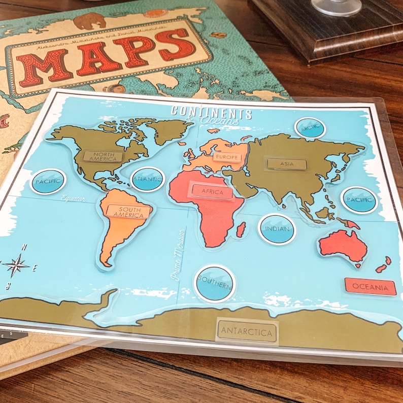 May include: A colorful world map with continents and oceans labeled. The map is divided into continents, including North America, South America, Europe, Asia, Africa, Australia, and Antarctica. The oceans are labeled Pacific, Atlantic, Indian, and Southern.