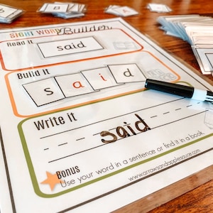 May include: A printable worksheet for building the sight word "said". The worksheet has three sections: "Read it", "Build it", and "Write it". The word "said" is written in a box in the "Read it" section. In the "Build it" section, the letters "s", "a", "i", and "d" are written in separate boxes. In the "Write it" section, the word "said" is written in cursive. The worksheet also includes a bonus section that says "Use your word in a sentence or find it in a book."