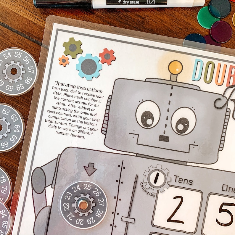 May include: A robot-themed educational game for kids. The game features a robot with a dial for each digit, a carrying cog, and a tens and ones place value chart. The game is designed to help children learn about numbers and math.