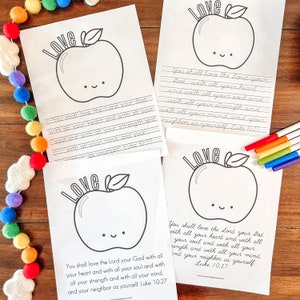 May include: Printable coloring page featuring a red apple with a smiling face and the text "Love" above it. The page includes the Bible verse "You shall love the Lord your God with all your heart and with all your soul and with all your strength and with all your mind, and your neighbor as yourself. Luke 10:27."