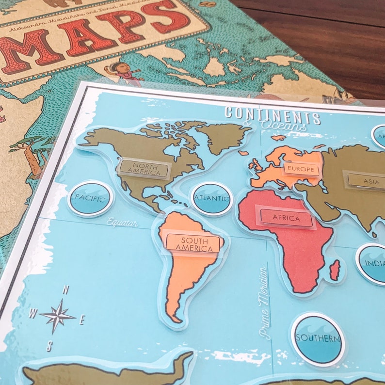 May include: A blue and white world map with continents and oceans labeled. The continents are cut out and can be moved around the map. The map includes the following labels: North America, South America, Europe, Africa, Asia, Pacific, Atlantic, Southern, and India.