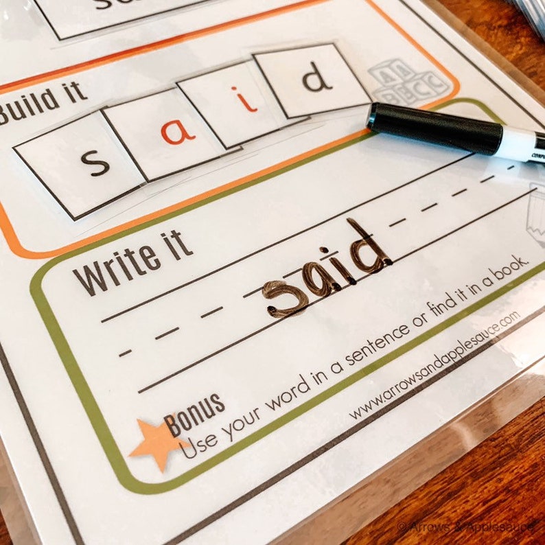 May include: A worksheet with the word "said" spelled out using letter tiles. The word is written on a line below the tiles. The worksheet also includes the instructions "Build it" and "Write it".