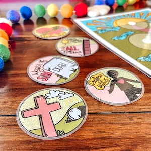 May include: A set of six colorful round stickers with religious messages. The stickers feature illustrations of a cross, a heart, a tombstone, and a person. The text on the stickers includes "Wages of Sin is Death", "Confess & Believe", and "All You Need is Love".