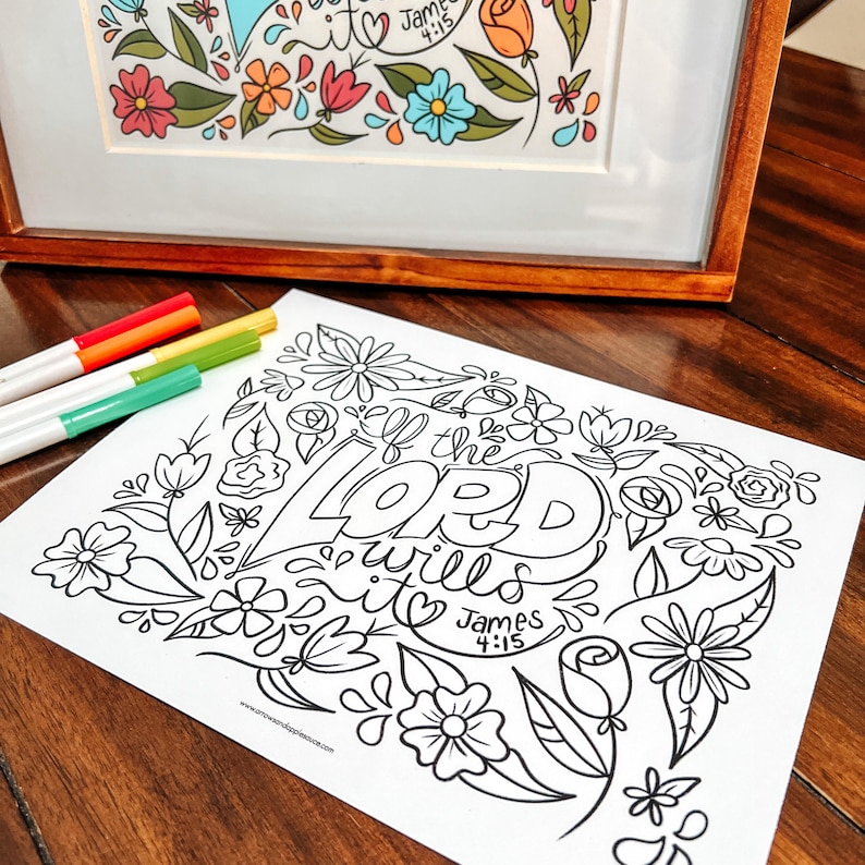 May include: A framed floral art print with colorful flowers and the text "James 4:15". A black and white coloring page with the words "If the Lord wills it" and floral designs is in the foreground. Four colored markers are on the left.