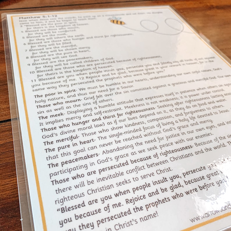 May include: A yellow and black bee illustration with a speech bubble containing the text "Matthew 5:1-12". The text below the bee is a list of verses from the Bible, including "Blessed are the poor in spirit", "Blessed are those who mourn", "Blessed are the meek", "Blessed are those who hunger and thirst for righteousness", "Blessed are the merciful", "Blessed are the pure in heart", "Blessed are the peacemakers", and "Blessed are those who are persecuted because of righteousness".