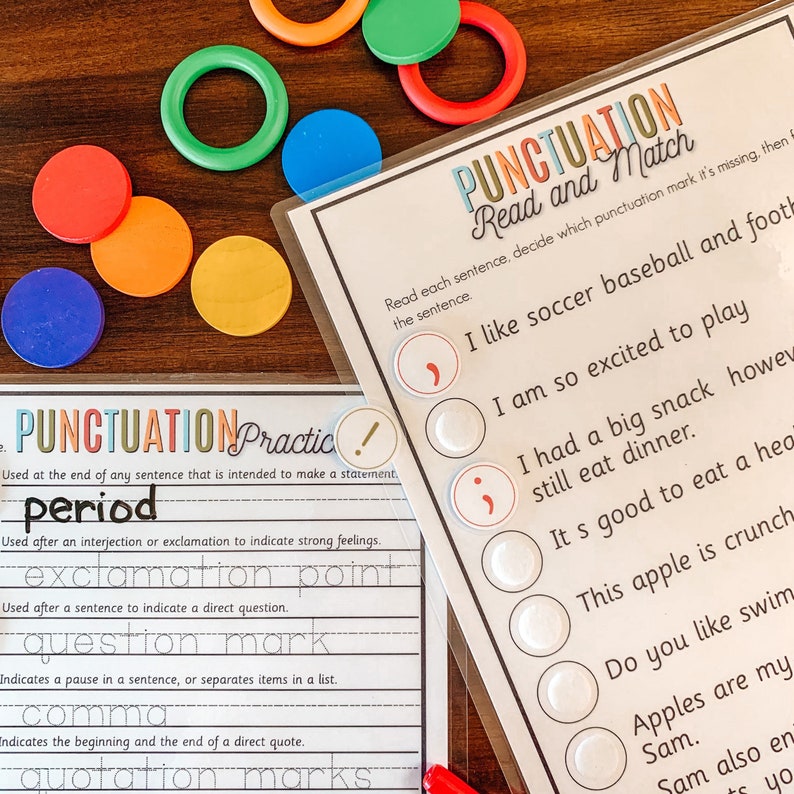 May include: A colorful educational game for kids to learn about punctuation. The game includes a set of colorful circles with punctuation marks and a worksheet with sentences that need punctuation. The worksheet includes the text: "PUNCTUATIONPractic! Used at the end of any sentence that is intended to make a statement. period Used after an interjection or exclamation to indicate strong feelings. exclamation point Used after a sentence to indicate a direct question. question mark Indicates a pause in a sentence, or separates items in a list. comma Indicates the beginning and the end of a direct quote. quotation marks"