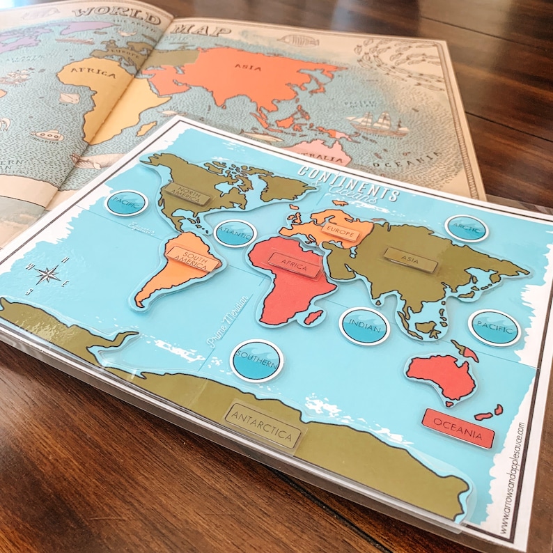 May include: A blue and green world map with continents outlined in brown. The continents are labeled with their names: North America, South America, Africa, Europe, Asia, Australia, and Antarctica. The oceans are labeled: Arctic, Atlantic, Indian, Pacific, and Southern.