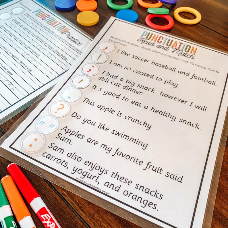 May include: A printable worksheet with the title "Punctuation Read and Match" and a series of sentences with missing punctuation marks.  The sentences are about sports, food, and swimming.  There are colorful circles with punctuation marks to match to the sentences.