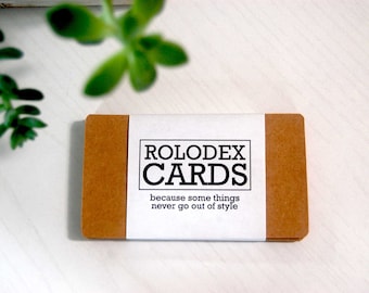 May include: A brown cardboard box with a white label that says "ROLODEX CARDS because some things never go out of style".