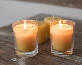 Set of 4 beeswax votive candles with 2 clear glass holders and 2 refills