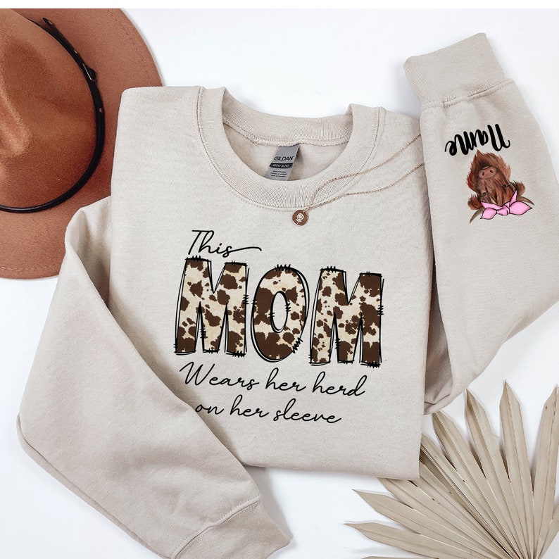 a sweater with a dog on it and a hat next to it