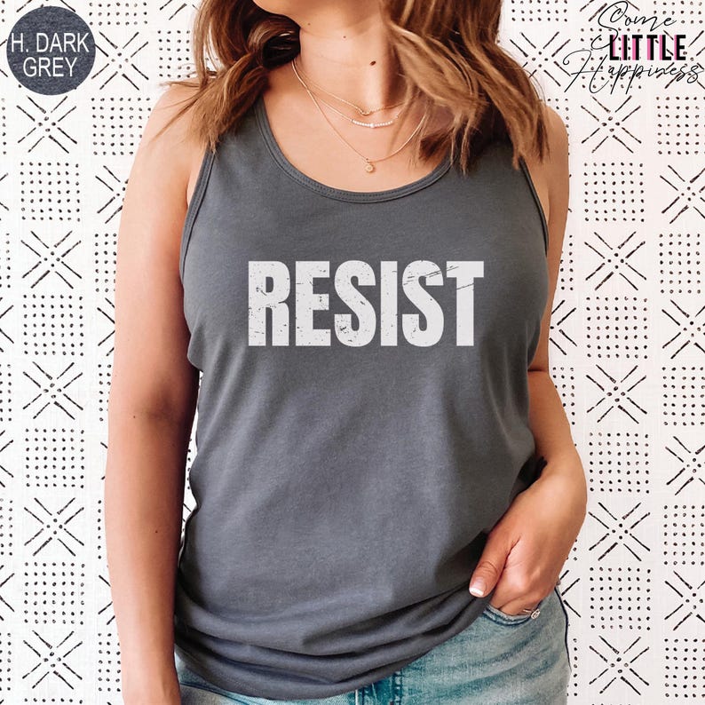 May include: A dark grey tank top with the word "RESIST" printed in white on the front. The text has a distressed, vintage look.