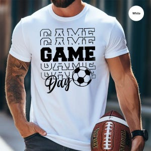 a man holding a football and a ball