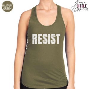 May include: A green tank top with the word "RESIST" printed in white on the front.