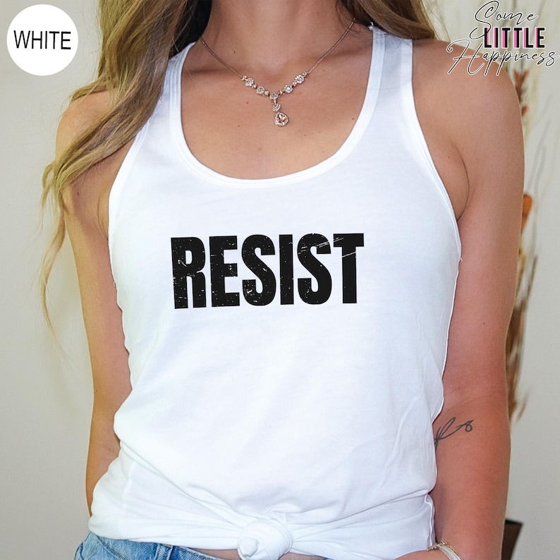 May include: White tank top with the word "RESIST" printed in black distressed lettering.