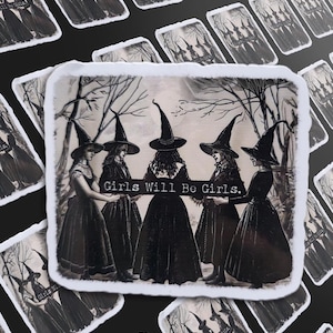 May include: A sticker with a vintage illustration of five women in black dresses and witch hats, set in a forest scene. The text "Girls Will Be Girls" is displayed. The sticker has a white border, with a slightly distressed edge.