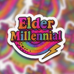 May include: A colorful sticker with the words "Elder Millennial" in a retro font. The design includes a rainbow, a lightning bolt, and glitter accents. The sticker has a white border and a vibrant, eye-catching aesthetic.