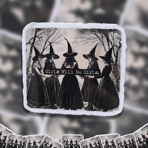 May include: A sticker with a vintage illustration of five women in witch hats and long dresses, set in a forest scene. The text "Girls Will Be Girls" is displayed. The sticker has a white border and a slightly aged look.