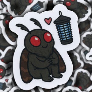 May include: A black and brown moth with red eyes sits with its wings folded, looking at a blue bug zapper with a heart above it.