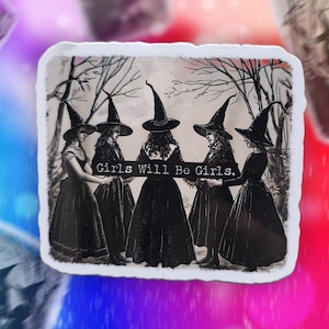 May include: A sticker depicting five women in witch hats and long dresses, set against a forest backdrop. The words "Girls Will Be Girls" are printed across the image. The sticker has a white border.