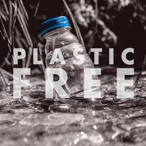May include: A blue plastic water bottle with a blue cap is partially submerged in a stream. The words "PLASTIC FREE" are superimposed over the image in white text.