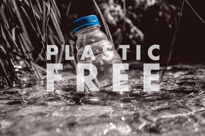 May include: A blue plastic water bottle with a blue cap is partially submerged in a stream. The words "PLASTIC FREE" are superimposed over the image in white text.