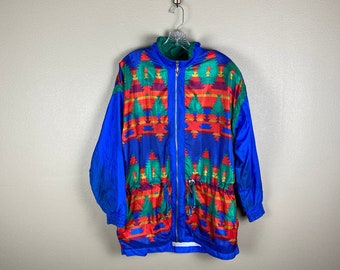 May include: A blue jacket with a colorful geometric pattern. The jacket has a zipper closure and a drawstring at the waist.