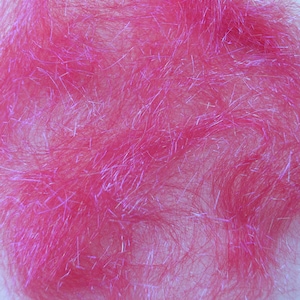 May include: Close-up of a vibrant pink, fluffy material with iridescent strands. The texture appears soft and dense, with a slight sheen. The material is likely used for crafting or decorative purposes.