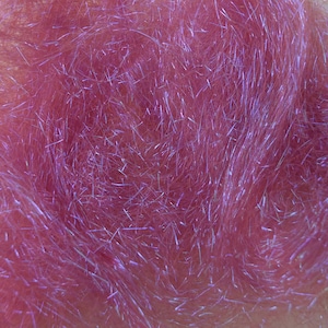 May include: Close-up of a mass of pink, iridescent synthetic fibers. The fibers are densely packed and have a shimmering, reflective quality, with highlights of silver and purple. The texture appears soft and fluffy, suitable for craft projects.