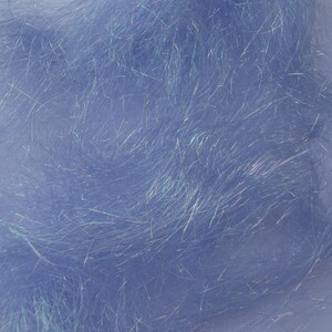 May include: Close-up of a mass of light blue, iridescent synthetic fibers. The fibers are long, thin, and have a shimmering quality, with strands of silver and blue. The material appears soft and fluffy, suitable for craft projects.