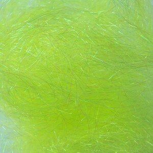 May include: Close-up of a vibrant, lime green material with a textured, fibrous appearance. The fibers are thin and slightly iridescent, creating a shimmering effect. The material has a soft, fluffy look, ideal for crafting or decorative purposes.