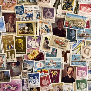 May include: A collection of vintage postage stamps, featuring various designs, portraits, and scenes. The stamps are in various colors, including blue, red, and yellow, and are arranged closely together.