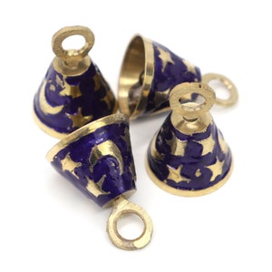 May include: Four small gold bells with blue enamel and gold star and crescent moon designs. The bells have a loop at the top for hanging.