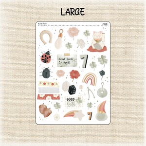 May include: A sheet of stickers with a variety of good luck charms, including a horseshoe, a ladybug, a four-leaf clover, a rainbow, a dice, a wishbone, a lucky cat, and a pot of gold. The stickers are on a white background and have a whimsical, hand-drawn style.
