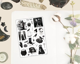 May include: A sheet of black and white Halloween stickers featuring a variety of spooky and magical imagery, including a skull, a black cat, a cauldron, a book with a pentagram, a raven, a ghost, and a pumpkin. The text "The Veil" is at the top of the sheet.