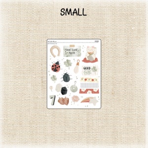 May include: A sheet of stickers with a good luck theme. The stickers feature a horseshoe, a ladybug, a four-leaf clover, a cat, a dice, a horseshoe, a star, a rainbow, and more. The stickers are on a white background.