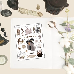 May include: A sheet of stickers with a witchy theme. The stickers feature a witch with long gray hair, a cauldron, crystals, moons, snakes, and the text "Witchy Vibes Only".