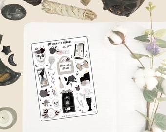 May include: A sheet of stickers with a black and white design featuring skulls, roses, hourglasses, and other gothic imagery. The stickers are labeled "Memento Mori".