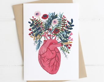 Anatomical human heart and flowers Valentine's card