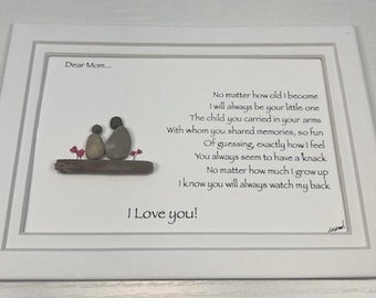 May include: A framed pebble art piece with a poem about a mother and child. The poem reads "Dear Mom... No matter how old I become I will always be your little one The child you carried in your arms With whom you shared memories, so fun Of guessing, exactly how I feel You always seem to have a knack No matter how much I grow up I know you will always watch my back I Love you!"
