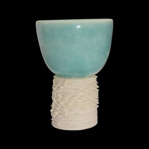 May include: A set of three ceramic mugs with a speckled, matte finish. Each mug is a different colour: light blue, cream, and grey. The mugs have a simple, modern design and a comfortable handle.