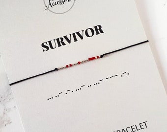 May include: A black string bracelet with red and white beads spelling out "SURVIVOR" in Morse code. The bracelet is displayed on a white card with the word "SURVIVOR" printed in black and the text "MORSE CODE BRACELET" printed in black below. The website address "www.floraaccessorieshop.etsy.com" is printed in black below the text.