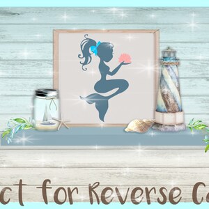 May include: A blue silhouette of a mermaid holding a pink seashell in a white frame on a shelf with a lighthouse, a jar with a sailboat, and seashells. The text "Perfect for Reverse Canvas" is at the bottom of the image.