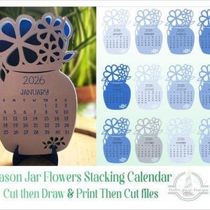 May include: A 2026 desktop calendar featuring a mason jar design with floral cutouts. The calendar includes twelve individual monthly pages in shades of blue, each displaying the month name, dates, and a flower arrangement at the top of the jar.