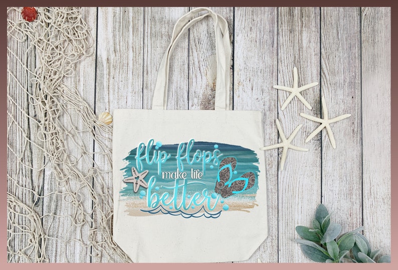 May include: A white canvas tote bag with a blue and green watercolor design featuring the text "flip flops make life better" and a pair of flip flops. The bag is on a wooden surface with a starfish and a piece of fishing net.