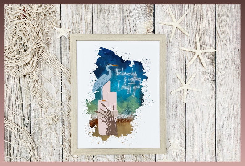 May include: A watercolor painting of a blue heron standing on a stack of pink candles with the text "The beach is calling I must go" in white. The background is a blue and green watercolor wash.